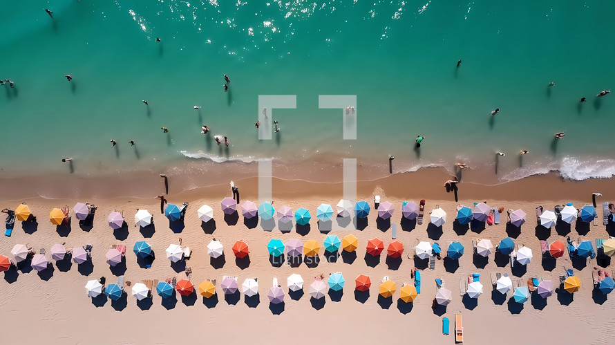 Vertical aerial view of a beach full of colorful umbrellas near the sea in Summer