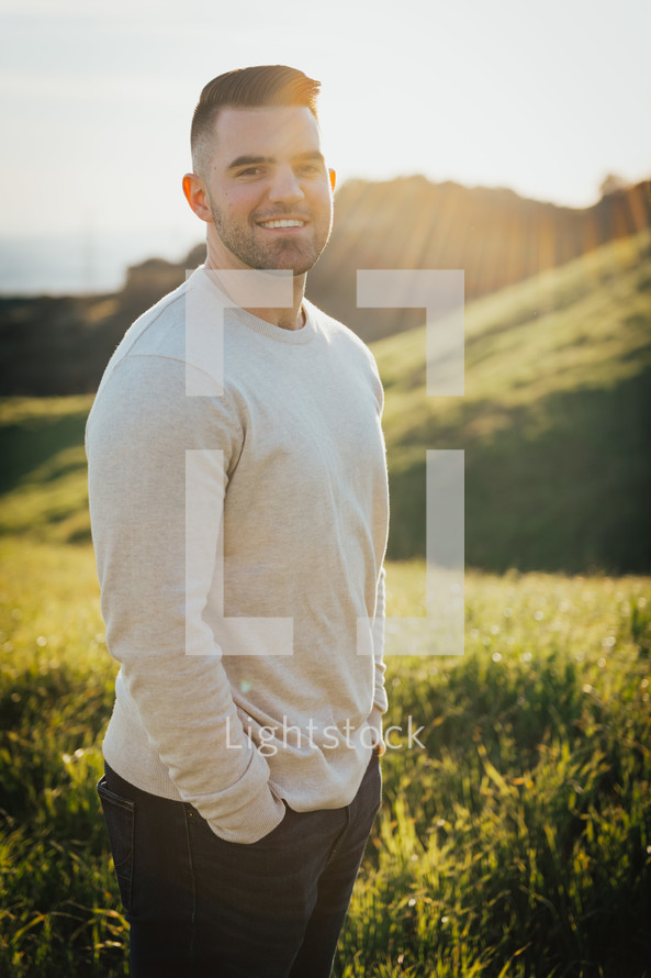 smiling man standing on a field 