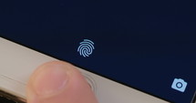 Fingerprint sensor unlocking a smartphone.