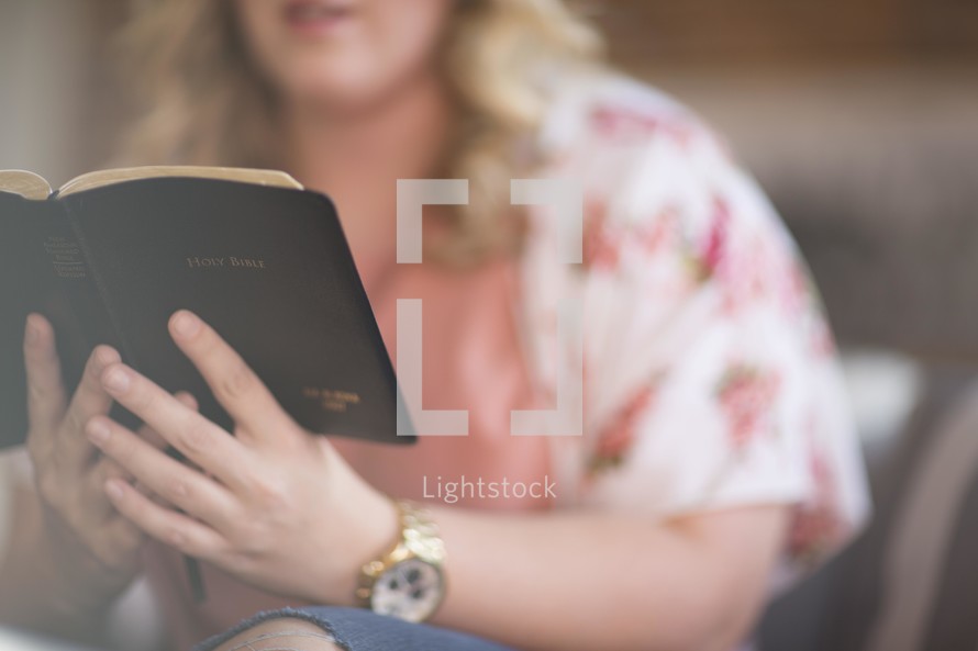 a woman reading a Bible at a Bible study 