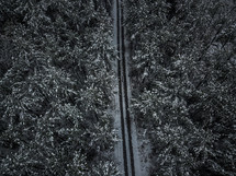 aerial view over tire tracks in snow on a road 