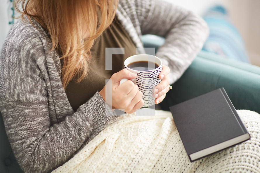 a woman sitting with a coffee mug 