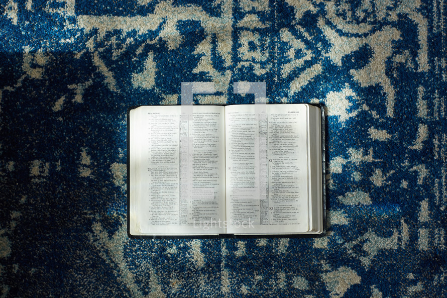 open Bible on a rug 