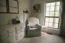 a newborn baby sleeping in a nursery chair 