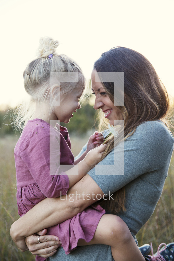 a mother and daughter hugging and laughing