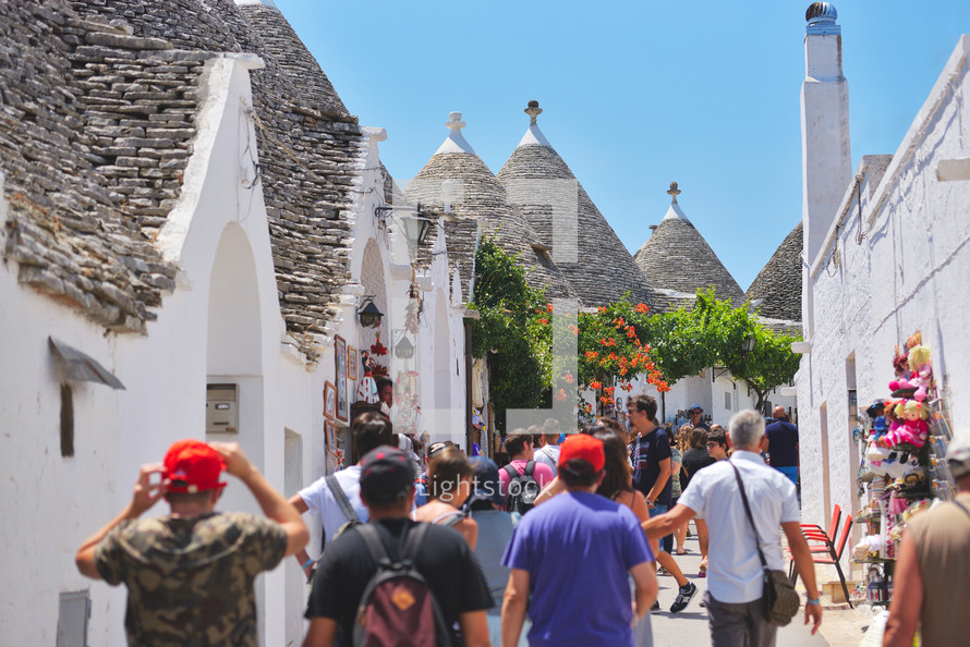 tourists and Trulli houses from the beautiful town Alberobello, Apulia, Italy