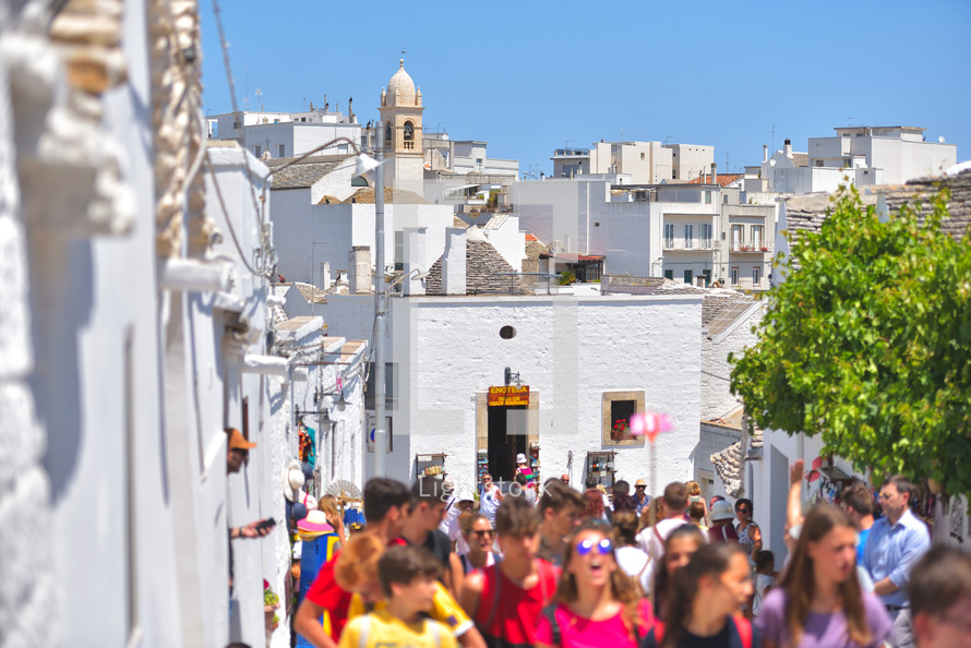 crowds visiting Trulli houses from the beautiful town Alberobello, Apulia, Italy