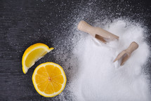 Plate with lemon and baking soda on wooden background