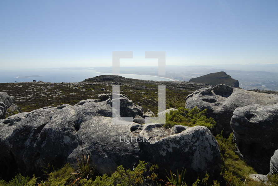 Rocks on the top of a coastal mountain top (Robben Island in the background)