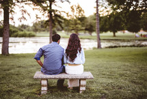 a couple sitting together on a bench 