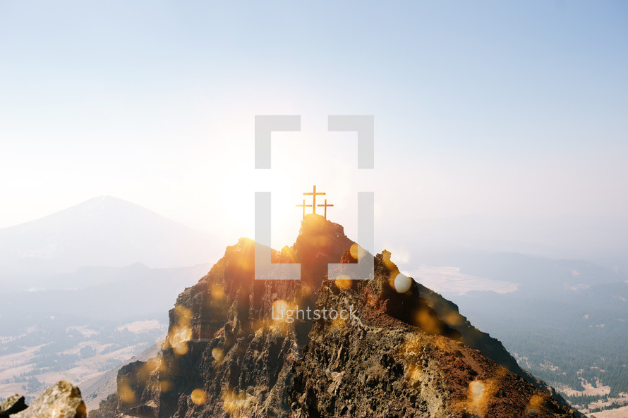 three crosses on a mountain peak 