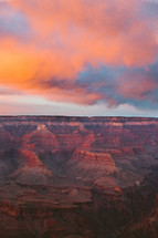 pink clouds at sunset over a canyon 