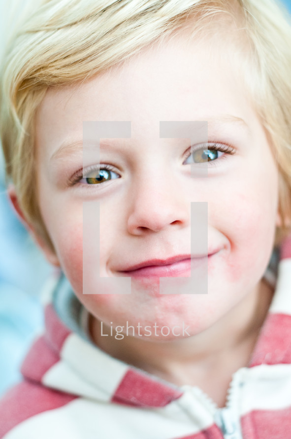 A blonde-haied boy smiling