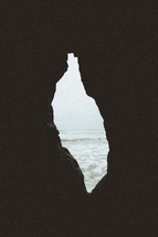 view of the ocean through a sea cave 