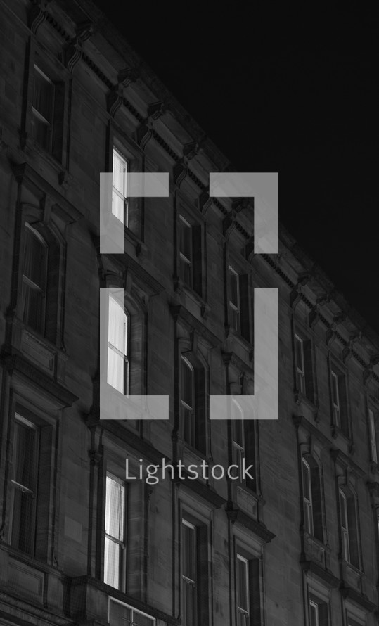lights on in the windows of an apartment building