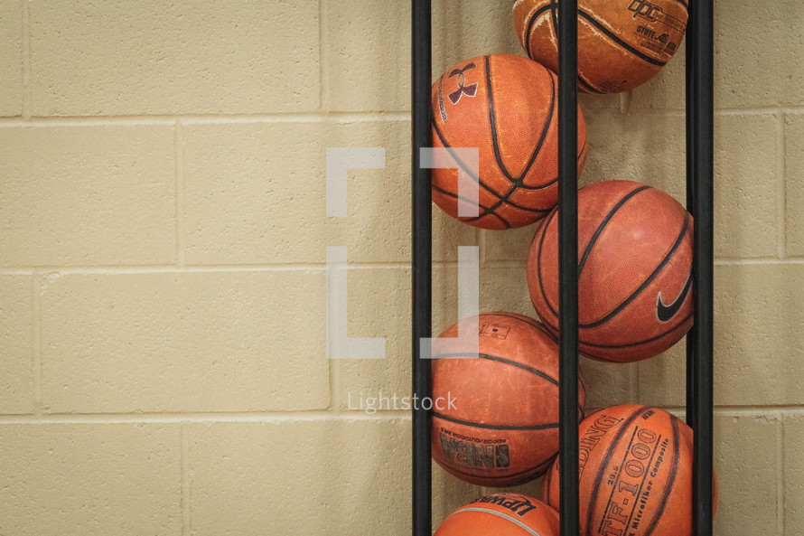 basketballs in a metal basket 