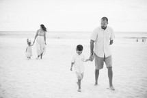 family walking on a beach 
