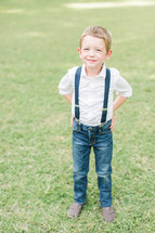 a happy boy child in suspenders 