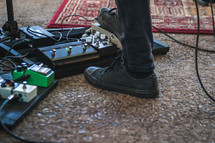 man's foot on a guitar foot pedal 