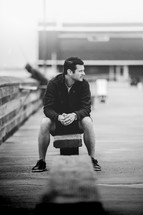 a man sitting on a pier 