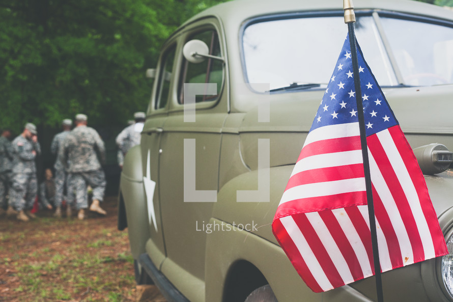 soldiers and American flag on a military police vehicle 