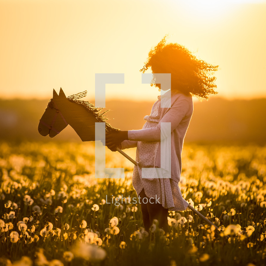 a girl in a field of dandelions 