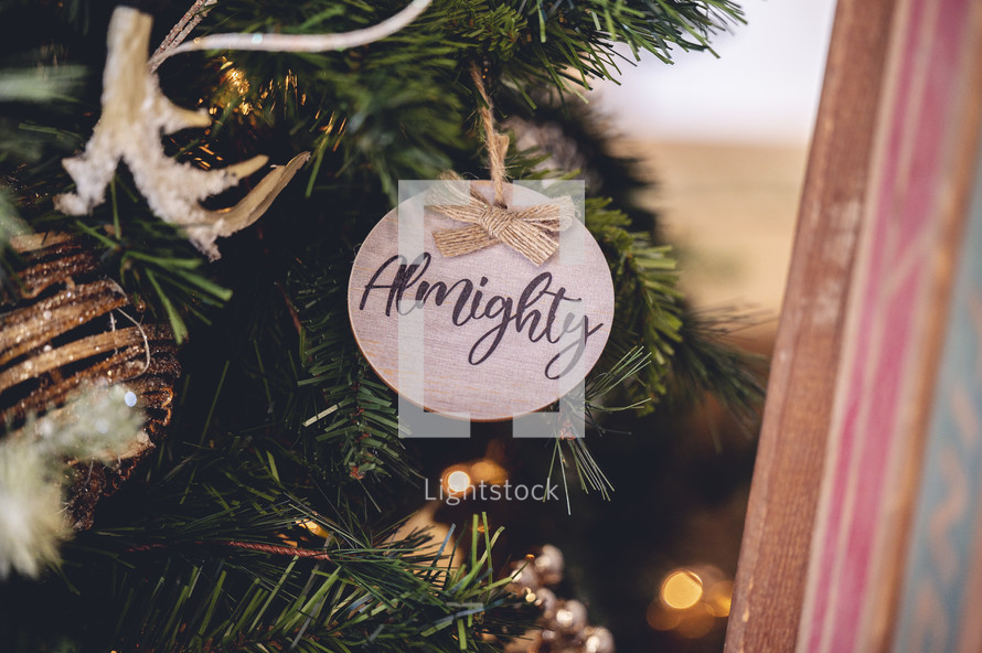 Wooden ornament with the word "almighty" on a Christmas tree 