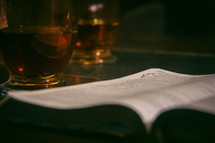 glass mug and open Bible 