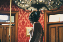 bride standing in a ballroom 