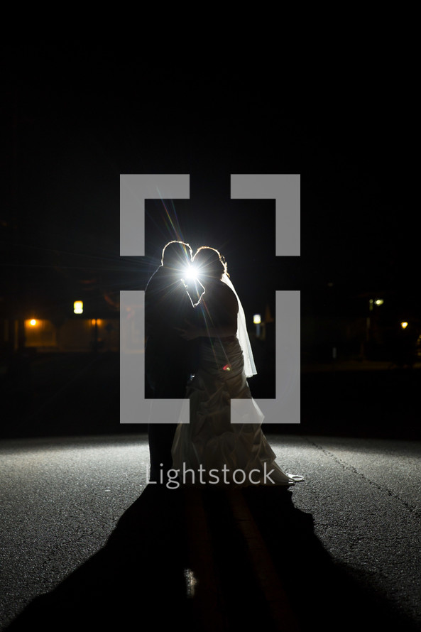 bride and groom dancing under a spotlight 