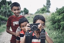 children holding a camera 