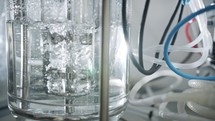 Slow motion shot of a mixer used in a chemistry lab to mix liquids