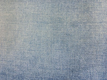 faded washed denim blue jeans background