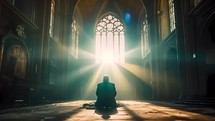 Silhouette of a man praying alone sitting in a cathedral with spirit light come from big window