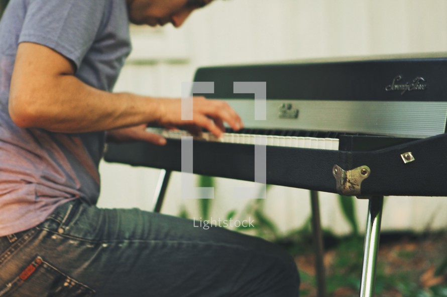 A man playing a keyboard.
