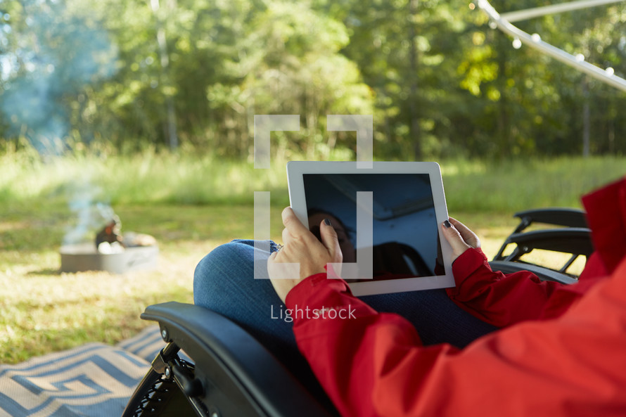 woman looking at an iPad screen outdoors 