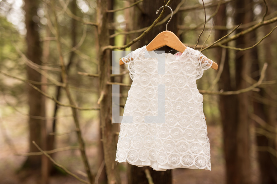 a lace shirt on a hanger 