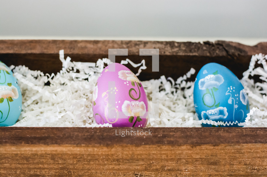decorated Easter eggs in a wooden box 
