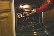 woman baking cookies in the oven 