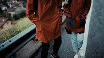 couple backpacking in rain gear 