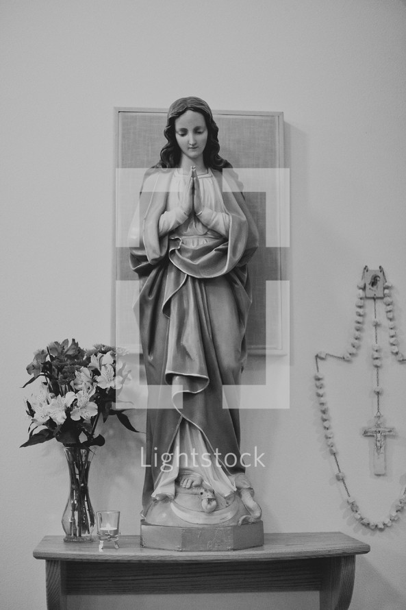praying Modonna statue and rosary 
