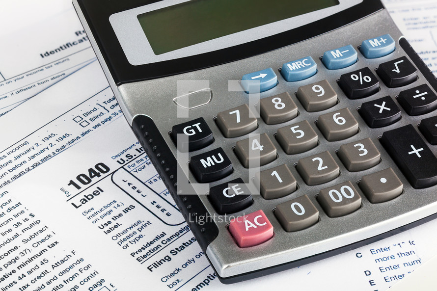 US Individual Tax Return Form 1040 close up with calculator