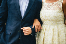 A man and woman standing arm in arm.