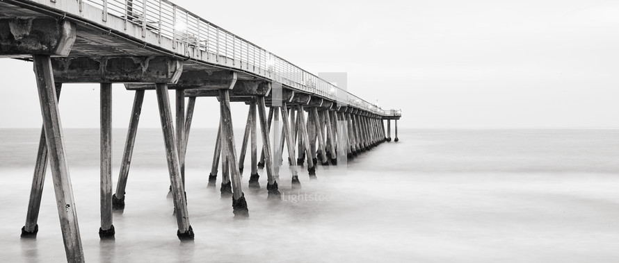 a pier extending into a calm ocean