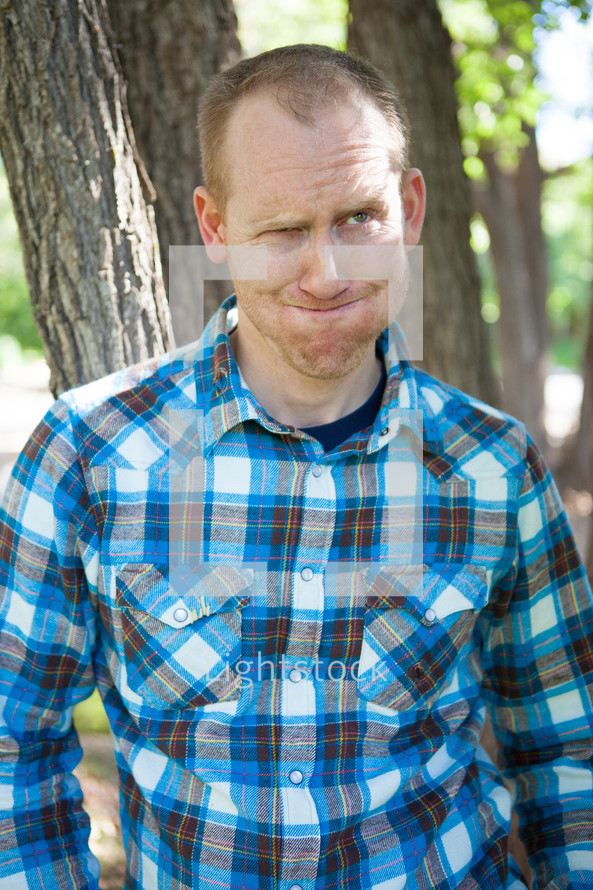 man in a plaid shirt making a silly face 