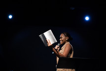 a female pastor leading a worship service 