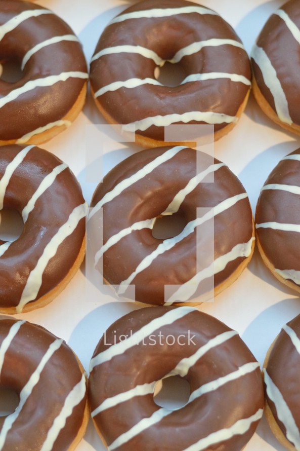 Chocolate covered donuts with white stripes