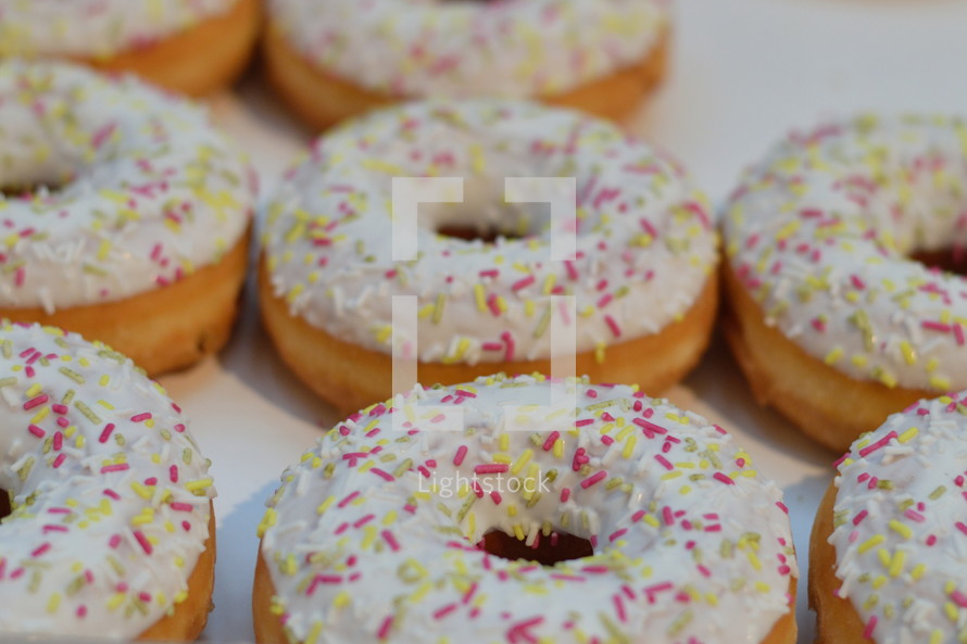 sugarcoated donuts with colorful sprinkles