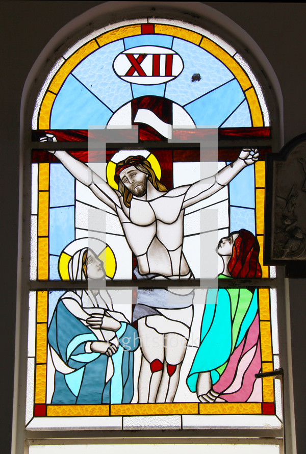 A stained glass window depicting Jesus on the cross.