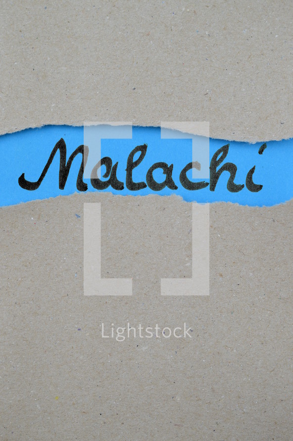 torn open kraft paper over blue paper with the name of the prophetic book Malachi
